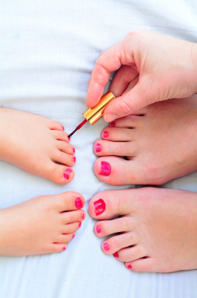 Mother and child paint their feet with nail polish Pamper Parties Grand Cayman